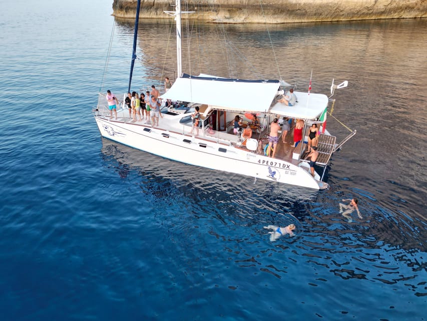 Lampedusa: Dolphin watching with aperitif at sunset - The cove stop and moonlight swim: what it adds (and what to watch for)