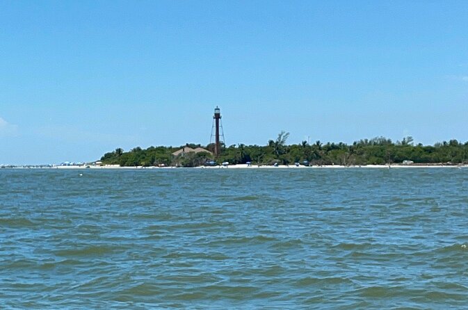 Private Dolphin & Sightseeing Boat Day Tour - Crossing toward Sanibel and photographing the lighthouse