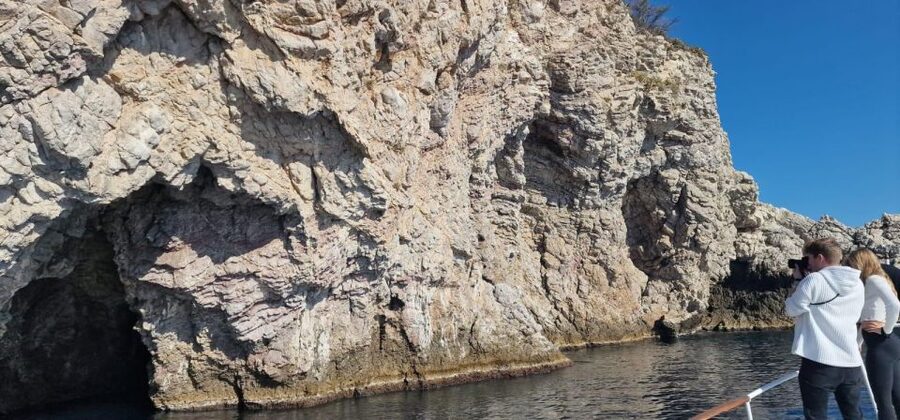 Sunset Tour and Searching Dolphins - Capo Taormina by sea: the Cave of Love and a famous hotel silhouette