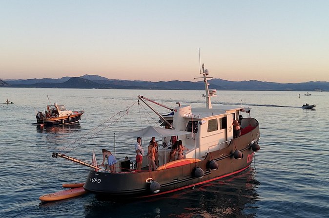 Sunset with dolphins on a vintage tugboat in Golfo Aranci - What you actually do at Cala Moresca (it’s more than a stop)